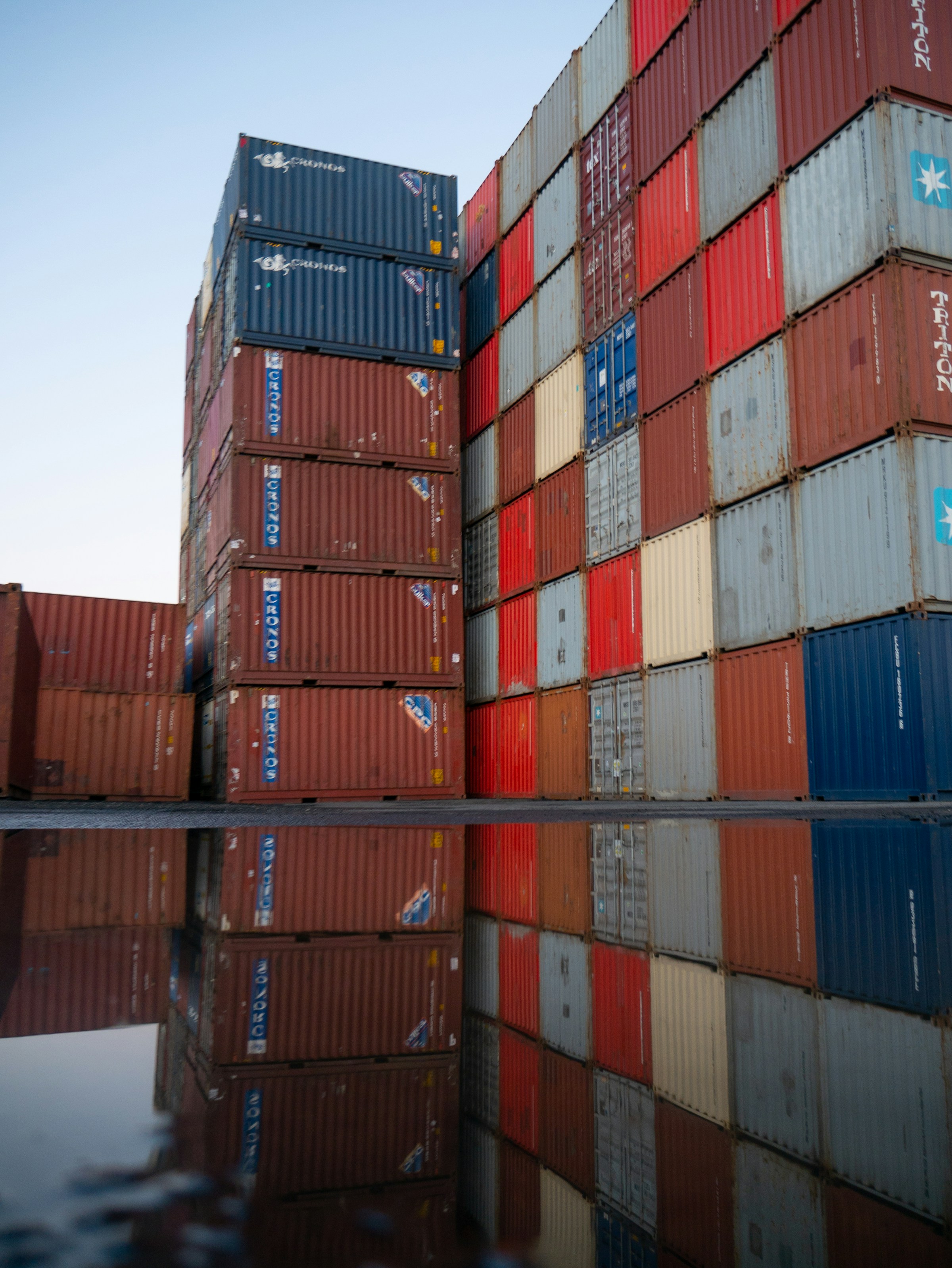 Stacked steel shipping containers in an industrial yard